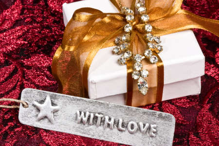 close of up of white gift box and jewelry - 'with love' tag