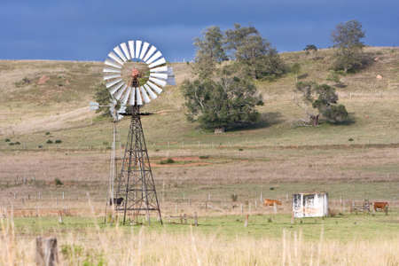 rural scene with windmill in country fieldの写真素材