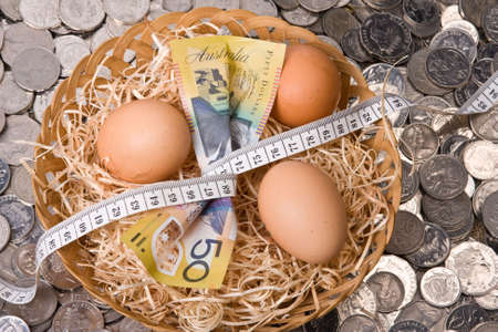 close up of money with eggs in nest with tape measure - australian currency notes and coinsの写真素材