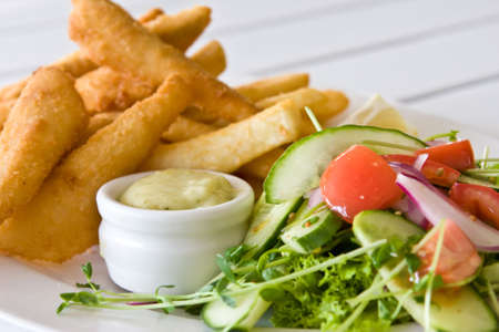 close of fresh garden salad with crumbed whiting filletsの写真素材