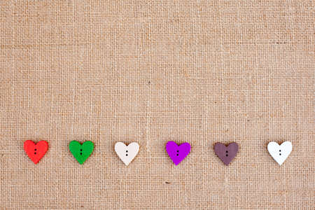 background - natural color burlap hessian with heart shape buttonsの写真素材