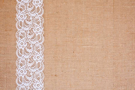 background - natural color burlap hessian with white lace borderの写真素材