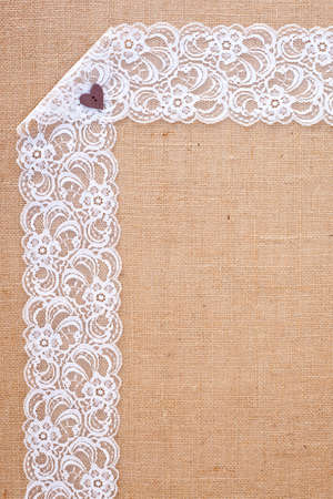 background - natural color burlap hessian with white lace borderの写真素材