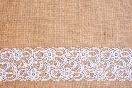 background - natural color burlap hessian with white lace borderの写真素材