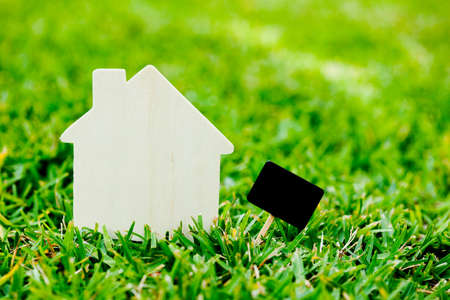 House and sign on grass backgroundの写真素材