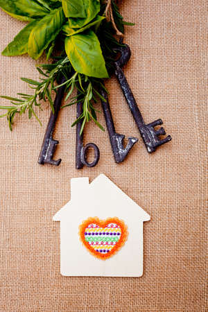 Love Keys with House and herbs on burlap backgroundの写真素材