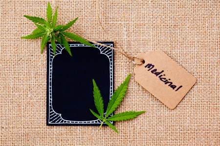 Marijuana - Cannabis - Medicinal with blackboard and tag on burlap hessian backgroundの写真素材