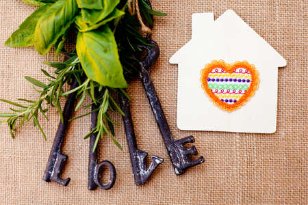 Love Keys with House and herbs on burlap backgroundの写真素材