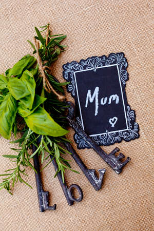 Mother's Day - Mum with love keys on burlap backgroundの写真素材