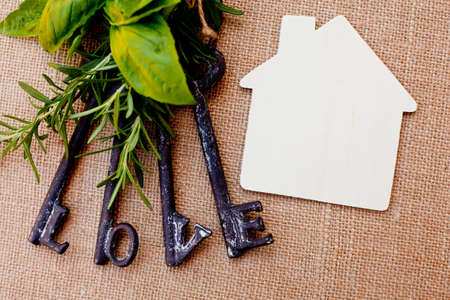 Love Keys with House and herbs on burlap backgroundの写真素材