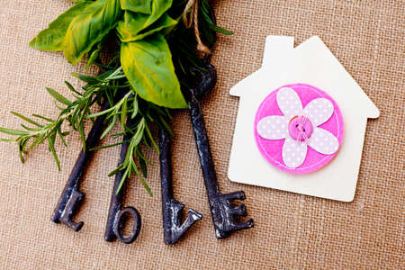 Love Keys with House and herbs on burlap backgroundの写真素材