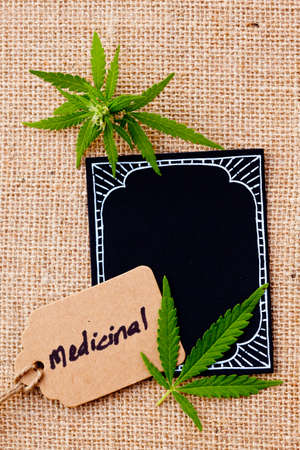Marijuana - Cannabis - Medicinal with blackboard and tag on burlap hessian backgroundの写真素材
