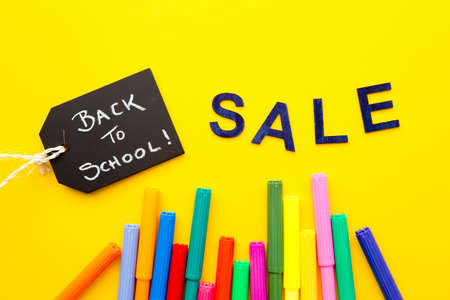 Back to School - Sale with colored pens on yellow backgroundの写真素材