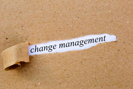 Change Management - printed text underneath torn brown paperの写真素材