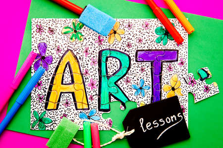 Art Jigsaw - hand drawn in colored pen on jigsaw puzzle with lessons written on chalkboardの写真素材