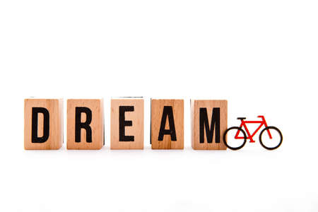 Dream Bike - wooden block letters and bike icon on white background