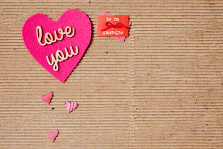 Love You - Be my valentine with pink hearts on corrugated paper backgroundの写真素材