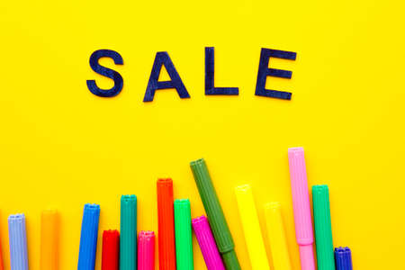 Art - Sale - wooden letters with colored pens on yellow backgroundの写真素材