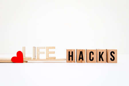 Red heart icon with Life Hacks in wooden letters with white backgroundの写真素材