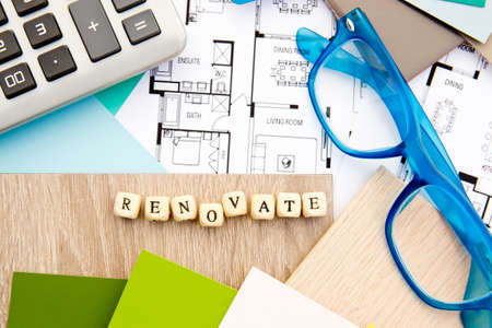 Renovate in block letters - with house drawings, samples, eyeglasses and calculatorの写真素材