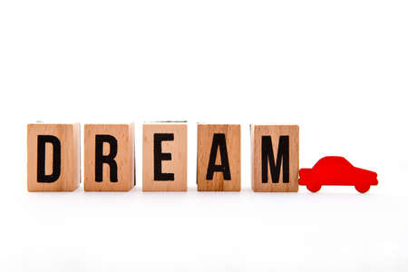 Dream Car - wooden block letters and red car icon on white backgroundの写真素材