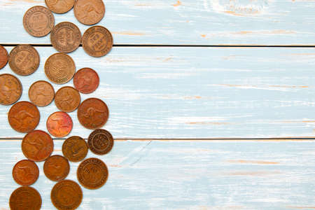 Old Coins on blue wooden backgroundの写真素材