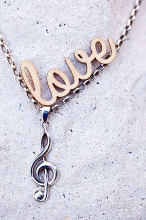 Love Music silver music necklace with love wooden lettersの写真素材