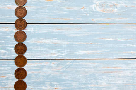 Old Coins on blue wooden backgroundの写真素材
