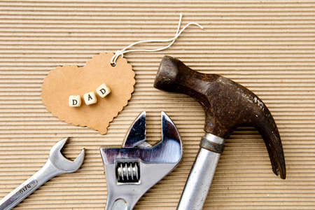 Father's Day - Dad on cardboard heart with assorted toolsの写真素材