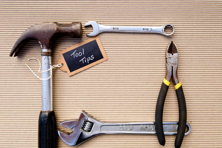 background - selection of tools on corrugated cardboard background with Tool Tips tagの写真素材