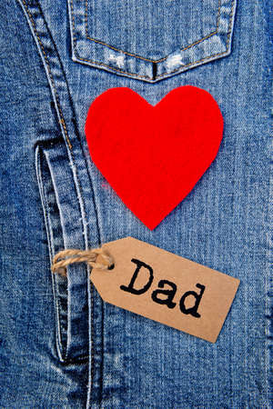 Dad tag with red heart on blue denimの写真素材