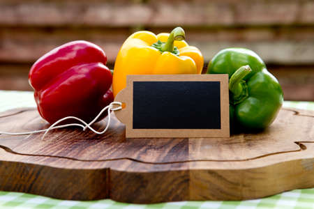Peppers - Capsicum with blank chalkboard - outdoor backgroundの写真素材