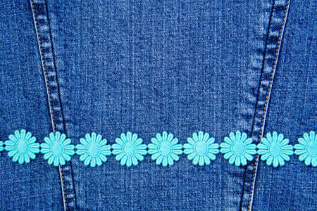 Daisy chain on denim backgroundの写真素材