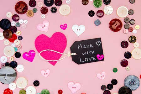 Sewing - Made with Love with buttons on pink backgroundの写真素材