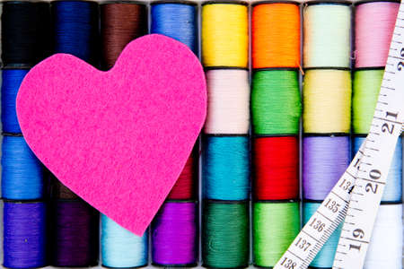 Sewing - Thread - Cotton Reels with pink felt heart and tape measureの写真素材