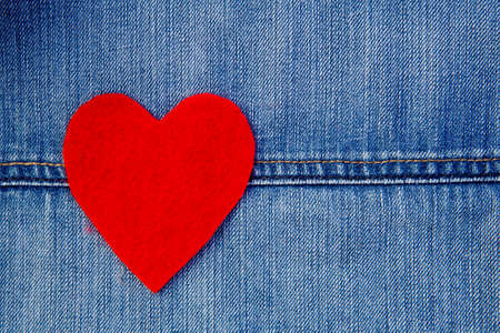 Red Felt heart on blue denimの写真素材