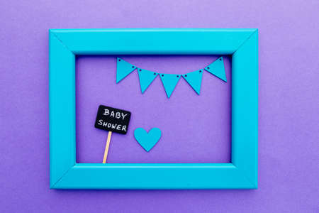 Baby Shower -blackboard sign on purple background with turquoise frame and buntingの写真素材