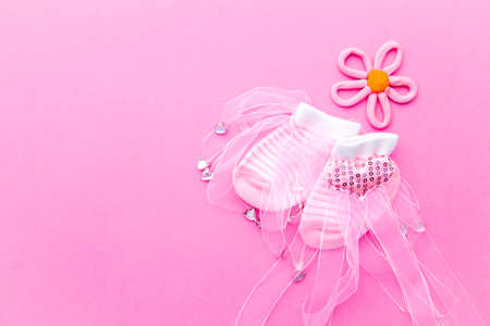 Baby Girl announcement background - pink and white socks with flower on pink backgroundの写真素材