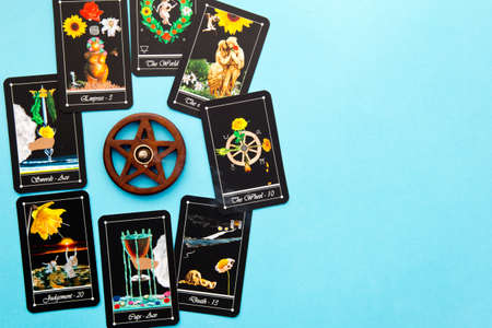 Tarot readings with deck of Tarot cards with wooden pentagram incense burner on blue backgroundの写真素材