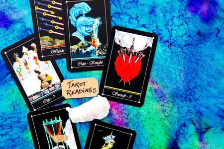 Tarot readings with deck of Tarot cards on multi colored silk reading clothの写真素材