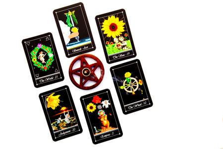 Tarot readings with deck of Tarot cards with wooden pentagram incense burner on white backgroundの写真素材