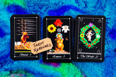 Tarot readings with deck of Tarot cards on multi colored silk reading clothの写真素材