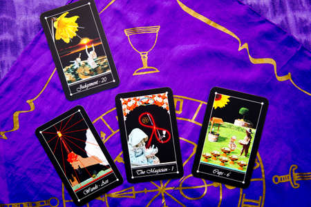 Tarot readings with deck of Tarot cards with purple silk reading cloth with gold cup patternの写真素材