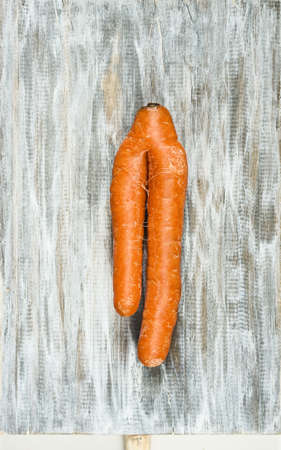 Siamese carrots on a wooden boardの写真素材
