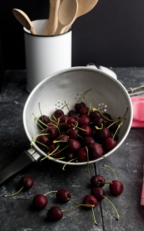 Fresh cherries in a colanderの写真素材