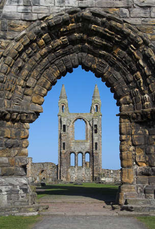 View of St Andrews Cathedral in Scotland through an ancient arched stone doorway. Once one of the most important religious centres in Scotland the Abbey declined after the Reformation leaving behind only these still impressive ruins.の写真素材