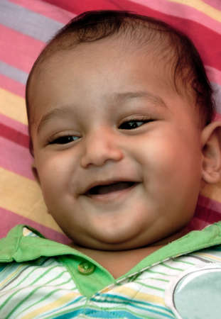 Young new born Indian baby boy smiling 