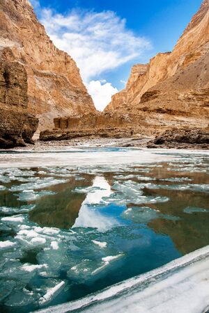 Nature mountains frozen zanskar river clean blue water. Reflection of mountain on flowing river.の写真素材