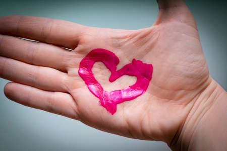 Hand with a painted heart. Love, symbol. Ich liebe dich.の写真素材