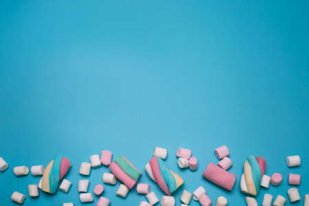 Marshmallows on the blue background, with free space for text.の写真素材